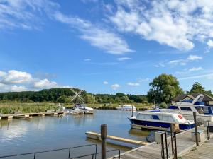 a marina with boats docked at a dock at Moorings House in Fritton Norfolk