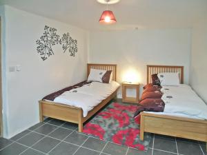 a bedroom with two beds and a rug at Proper Job in Tresmeer
