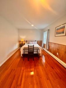 a bedroom with a bed and a table and chairs at 2 BR Private Suite Near Major Hospitals, Yale & DT in Woodbridge