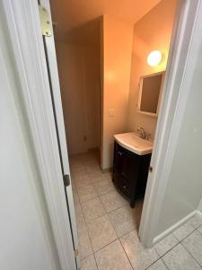 a bathroom with a sink and a mirror at 2 BR Private Suite Near Major Hospitals, Yale & DT in Woodbridge