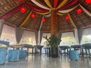 a large room with tables and chairs and red lanterns at Cozy Son Hotel in Ninh Binh