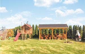 a park with a playground with a house and a slide at Beautiful Home In Mscice With Kitchen in Mścice +6 photos