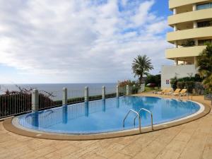 a swimming pool with the ocean in the background at Finest Rentals - Beachfront Penthouse in Funchal