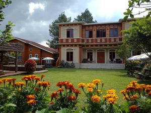 a large house with flowers in the yard at Villa Fresh Line in Bongkar 2