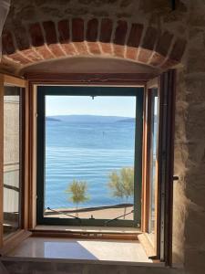 a large window with a view of the water at Knez apartments and rooms in Kaštela