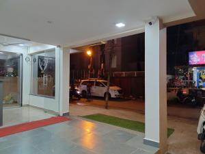 a room with a view of a street at night at C V Inn in Baga