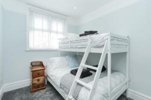 a bedroom with a bunk bed with a ladder at Atlas Place Broadstairs 4 bed family accommodation in Kent