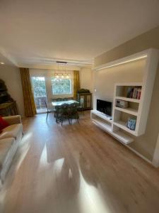 a living room with a table and a dining room at Appartamento a Dobbiaco nel cuore delle Dolomiti in Dobbiaco