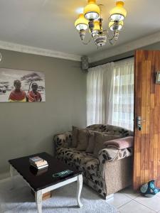 a living room with a couch and a table at Jobe Guesthouse in Pietermaritzburg