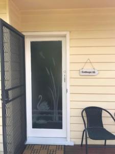 a front door of a house with a swan on it at Cottage 32 in Lakes Entrance