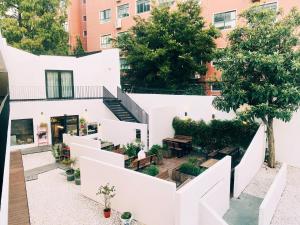 an aerial view of a white building with a courtyard at Shanghai Hidden Garden International Youth Hostel in Shanghai