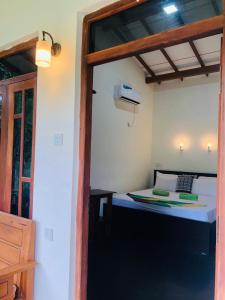 a room with a bed in a room with a window at Sigiri Liya Rest in Sigiriya