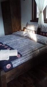 a bedroom with a bed with skulls on it at Yancheva Guest House in Delchevo