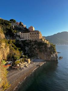 a building on the side of a mountain next to the water at Casa Angelica in Ravello