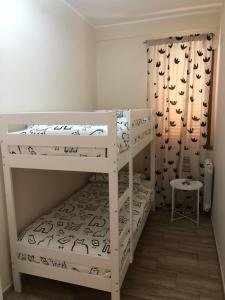 a bedroom with two bunk beds in a room at Etna holiday in Zafferana Etnea