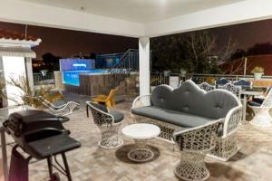 a group of chairs and a couch on a patio at Casa Ozuna in Mendoza