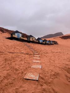 a path in the middle of a desert at Al Raha Luxury Camp in Wadi Rum