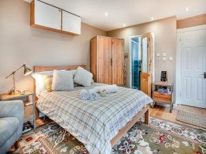 a bedroom with a bed with two stuffed animals on it at Goshawk Lodge in Abercarn