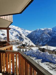 a view of a snow covered mountain from a deck at Studio vue montagne proche des pistes in Orcières