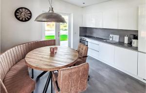 uma cozinha com uma mesa de madeira e algumas cadeiras em Wieringen em Den Oever