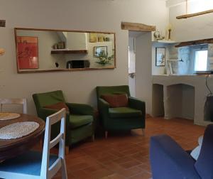 a living room with chairs and a table and a mirror at El Castell de Segueró in Beuda