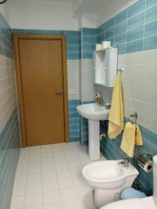 a bathroom with a toilet and a sink at Comfortable apartment in Shëngjin