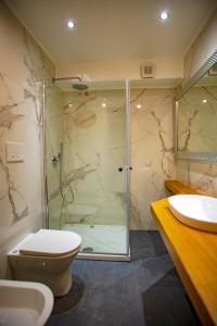 a bathroom with a shower and a toilet and a sink at Villa Letizia in Terracina