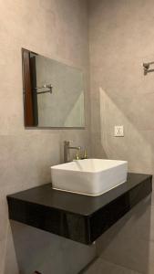 a white sink on a black counter in a bathroom at Laluna Guesthouse in Siem Reap