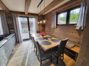 un comedor con una mesa larga y sillas en Hillview Jasná Chalet, en Demänovská Dolina