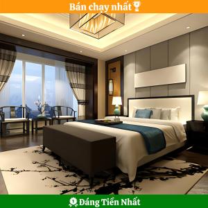 a bedroom with a king bed and a living room at Phuc Thanh Luxury Hotel by THG in Danang