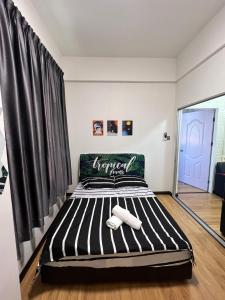 a large bed in a room with a window at KW HOMESTAY CASA UNO APARTMENT in Sandakan