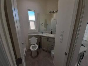 a bathroom with a toilet and a sink and a mirror at 038 Tiny Home nr Grand Canyon South Rim Sleeps 4 in Valle