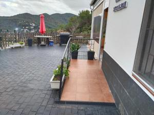 a balcony of a building with a table and chairs at Espacio Kybalion in Argentona