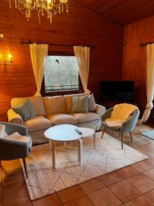 a living room with a couch and a table at Alb Landhaus in Inneringen-Hettingen