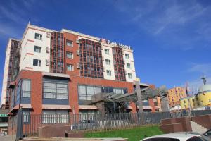 a red brick building with a sign on it at Park Hotel in Ulaanbaatar