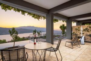 a table and chairs on a patio with a view at Heaven's Door in Samos