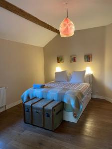 a bedroom with a bed with a wooden floor at La Bruyere du Coq Stables in Sart-Dames-Avelines