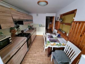 a kitchen with a table and a table and chairs at Wojciechówka in Ustka