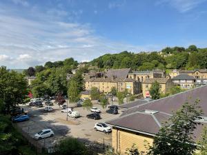 a town with cars parked in a parking lot at Large 4 double bedroomed townhouse in central Holmfirth in Holmfirth