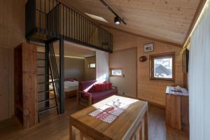 una sala de estar con una escalera en una cabaña en Bros Hof, en Malles Venosta