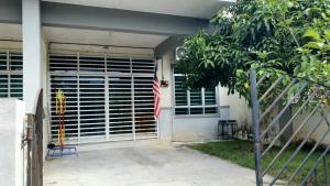 a house with a flag in front of a window at Homestay Ahmad Kuala Kangsar in Kuala Kangsar