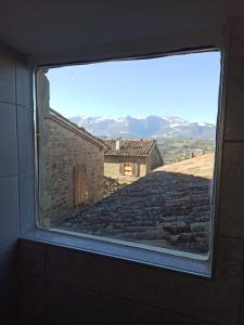 a view from a window of a stone building at fuga sui sibillini in Gualdo di Macerata
