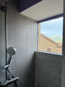 a shower in a bathroom with a window at fuga sui sibillini in Gualdo di Macerata