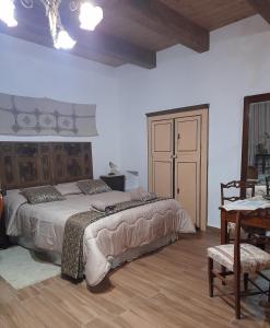 a bedroom with a large bed and a table at Casa Lanzara in Morano Calabro