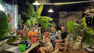 a group of people sitting at tables in a restaurant at Chú Trọc Homestay - Phan Rang Homestay & Camp in Phan Rang–Tháp Chàm