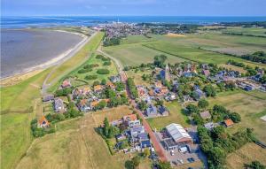 an aerial view of a village next to the beach at Ameland in Den Oever