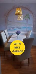 a dining room with a table with a bike garage sign at Koper Center Apartment in Koper