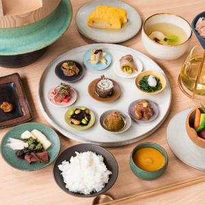 a table with plates of food and bowls of rice at Yado Arashiyama in Kyoto