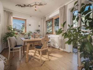 a dining room with a wooden table and chairs at Neschtl in Ramsau im Zillertal