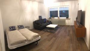 a living room with a bed and a couch at Ferienwohnung Waschbärglück in Hahnenklee-Bockswiese